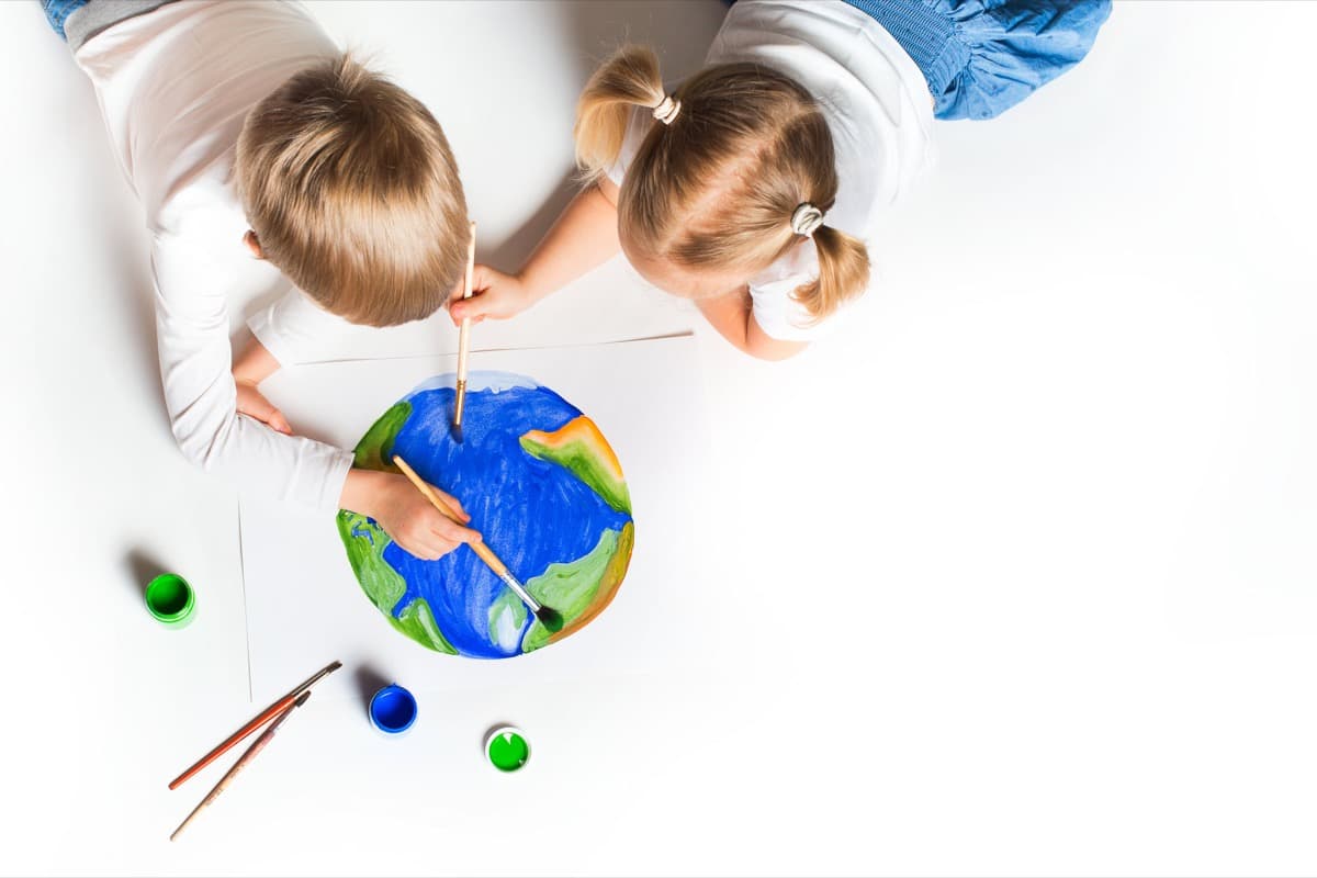 Children painting a globe together